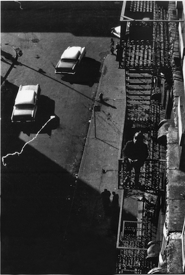 Black and white photograph taken from a height, looking out onto the street.