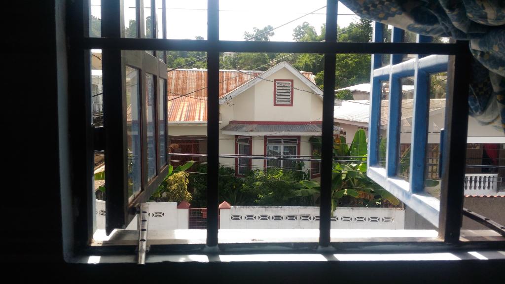 "view through window at house across street"