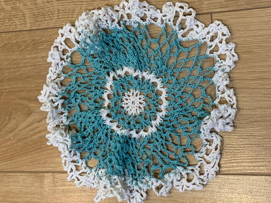 "crocheted doily in white and teal"