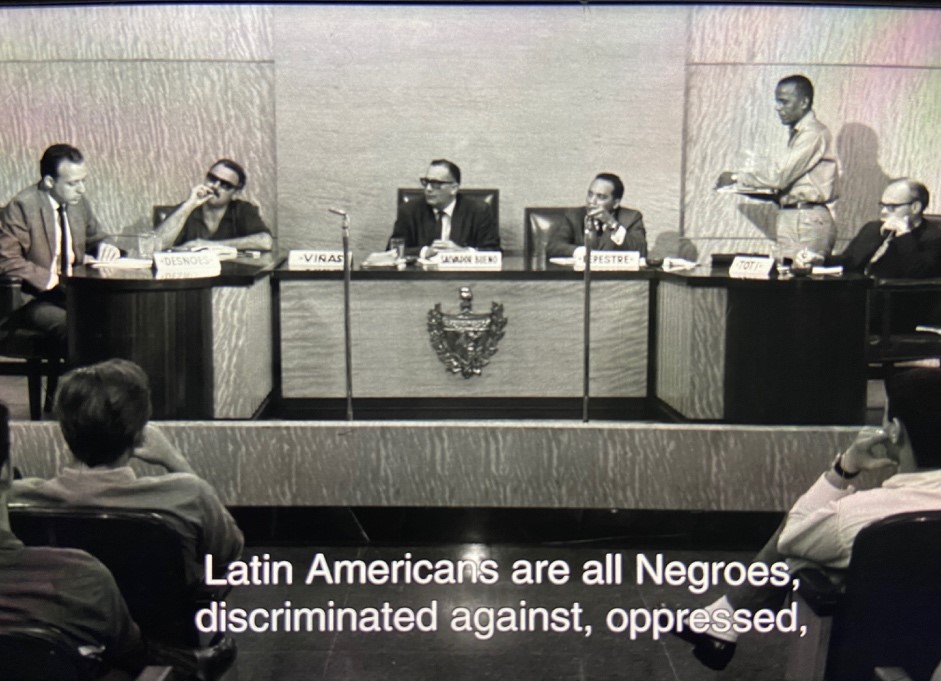 "black and white film still of men at conference"