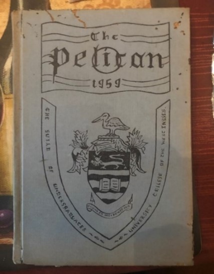"Black and white front cover of the 1959 annual of the Pelican magazine with a crest in the center"